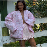 Women's pink printed knit cardigan with covered buttons for autumn and winter.